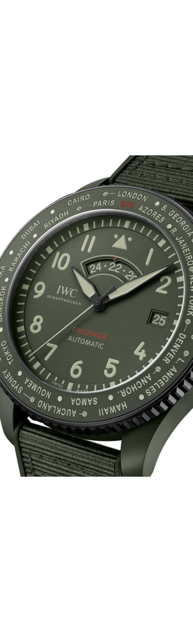 Close up image of IWC Pilot’s Watch Timezoner TOP GUN Woodland with green dial, ceramic case and green rubber strap with textile inlay.