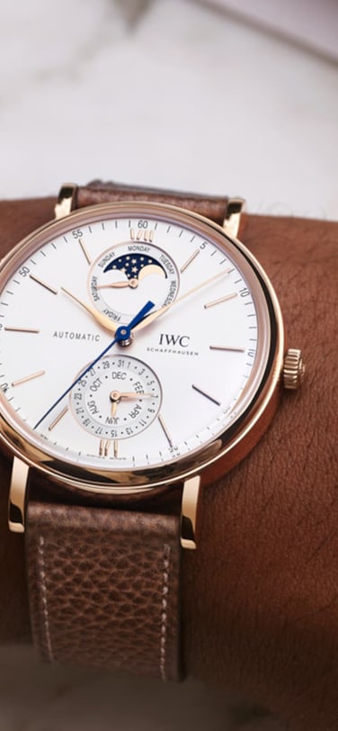 IWC Portofino Complete Calendar IW359002 with white dial, gold case and taupe calfskin strap.