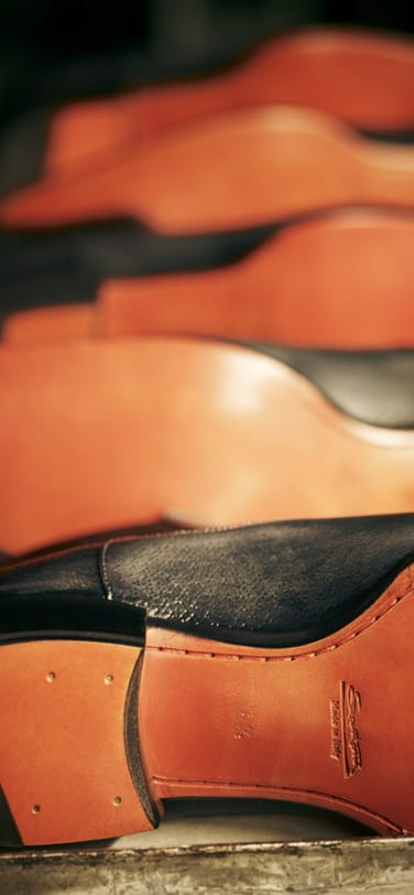 The underside of several leather shoes