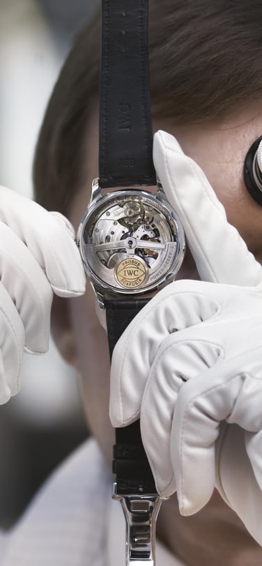 Image showing IWC watchmaker holding an IWC watch