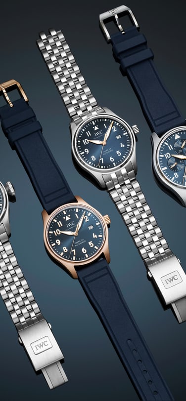 并排展示的四款IWC 飞行员系列腕表，展现多种表带选择