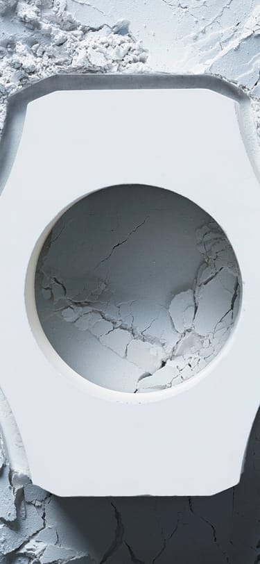 White ceramic case in the forground lying on top of ceramic material