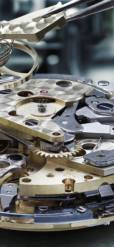 Close-up image of IWC watch mechanism and components inside watch dial