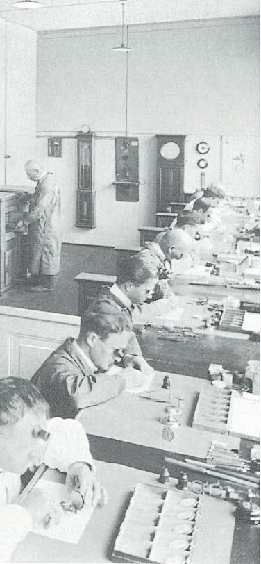 Old Black and White photo of watchmakers assembling watches in a large workshop