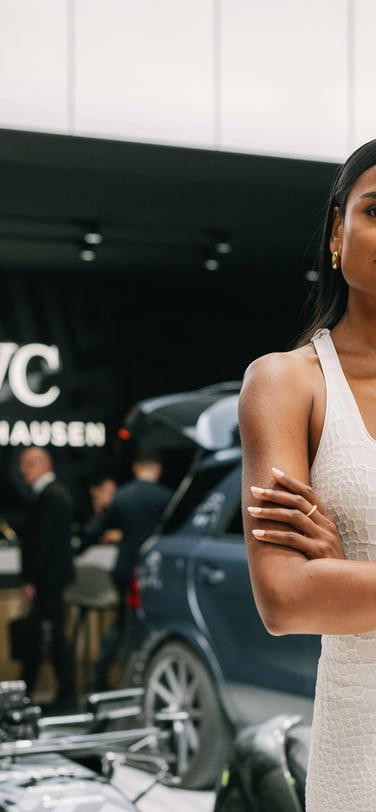 Simone Ashley wearing a white dress and IWC Ingenieur Automatic watch with rose gold case and bracelet