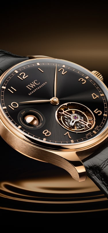 Portugieser Hand-Wound Tourbillon Day & Night with black dial, gold case and black strap