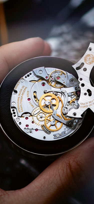 Partial view of an IWC watch where the 9 on the dial is visible.