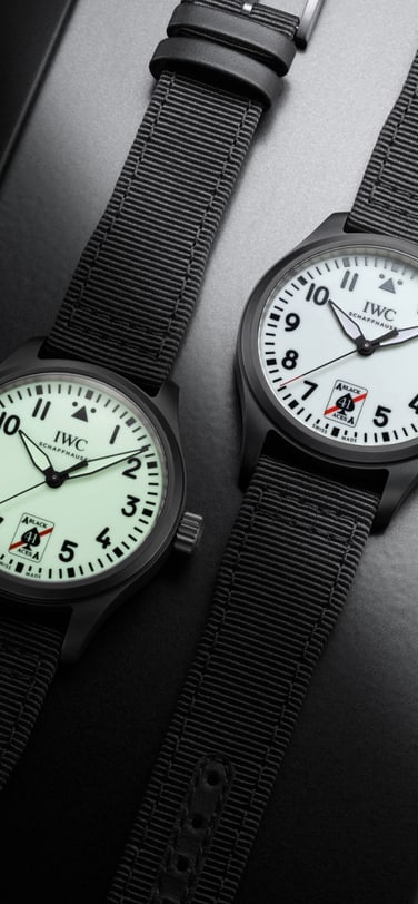 Two Pilot's Watch Automatic 41 Black Aces side by side, the left watch dial is displaying it's glow in the dark functionality