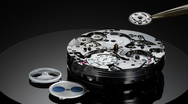 IWC Eternal Calendar complication with precision tool on black surface.