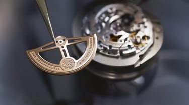 Close up of a metal power reserve timepiece object
