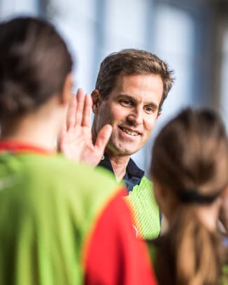 IWC CEO Chris Grainger-Herr with kids at a Laureus Academy event.